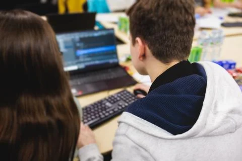 Software developer students in auditorium hall working on computer and lapt.. Stock Photos