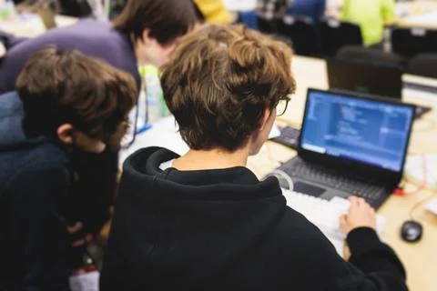 Software developer students in auditorium hall working on computer and lapt.. Stock Photos