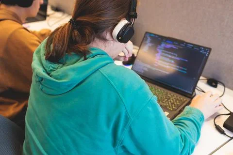 Software developer students in auditorium hall working on computer and lapt.. Stock Photos