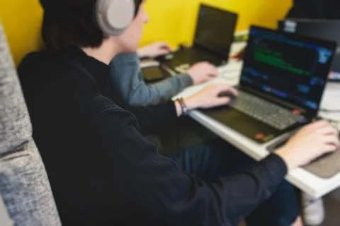 Software developer students in auditorium hall working on computer and lapt.. Stock Photos