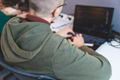Software developer students in auditorium hall working on computer and lapt.. Stock Photos