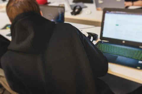 Software developer students in auditorium hall working on computer and lapt.. Stock Photos