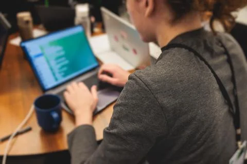 Software developer students in auditorium hall working on computer and lapt.. Stock Photos