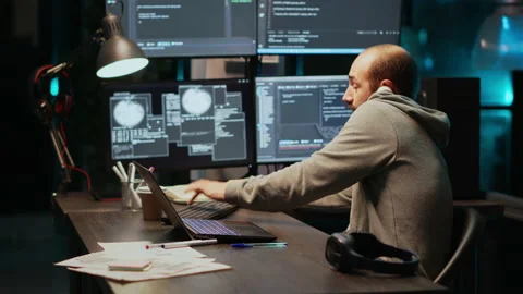 Software developer talking on landline phone at night Stock Footage 221523435