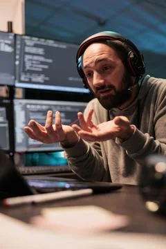 Software developer talking on online videoconference Stock Photos