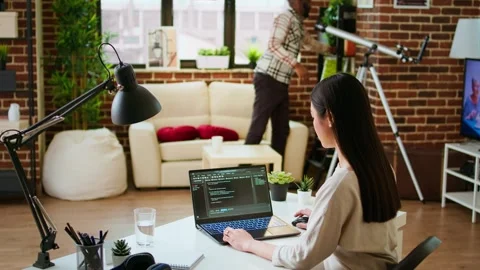 Software developer types programming code in a cozy home office setup Stock Footage 319712858