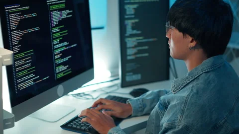 Software developer typing code debugging system on multi monitor setup for Stock Footage 313820815