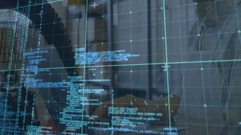 Software developer typing at desk, featuring translucent code overlay with Stock Footage 310218952