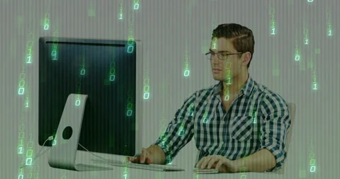 Software developer typing on keyboard and initiating binary matrix on monitor to Stock Footage 310330728