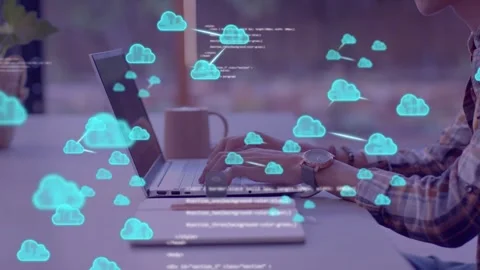 Software developer typing at laptop causing cloud icons and code overlays that 스톡 동영상 335466180