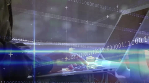 Software developer typing on laptop keyboard activating binary and code overlays Stock Footage 313509628