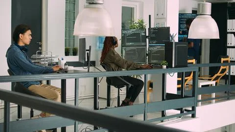 Software developer typing programming code on computer keyboard Stock Photos