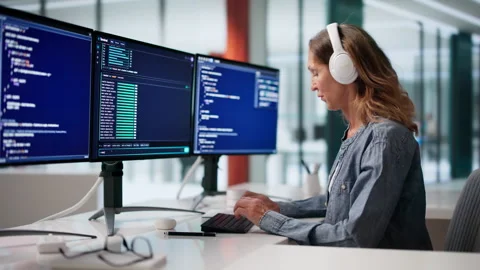 Software Developer Uses Cloud-based Coding Tools Wearing Headphones Stock Footage 336371831