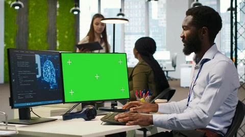 Software developer using AI on green screen computer to optimize performance Stock Photos