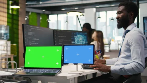 Software developer using AI on isolated screen laptop and tablet Stock Footage 313164799