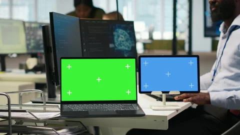Software developer using AI on isolated screen laptop and tablet Stock Footage 313165468