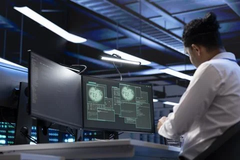 Software developer using computer in server room to support global connections Stock Photos