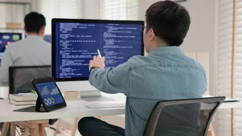 Software developer using generative AI automation code assistant help working Stock Footage 255692273