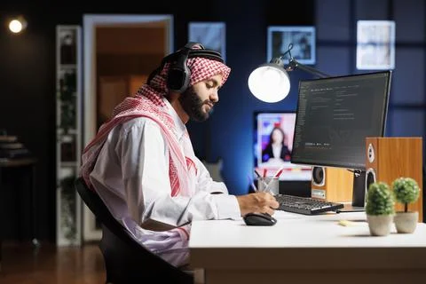 Software developer using headphones 스톡 사진