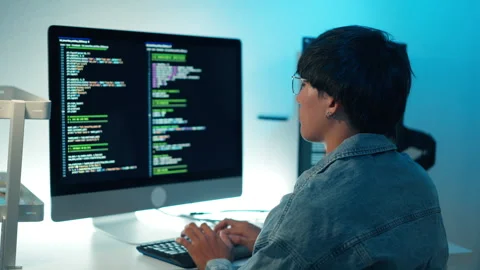 Software developer using keyboard debugging code programming task monitor screen Stock Footage 313820779