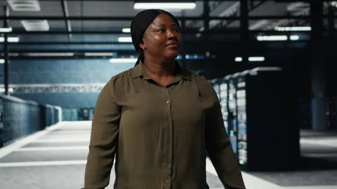 Software developer walking in data center, checking hardware Stock Footage 317204101