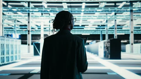 Software developer walks in data center, using tablet and AR technology Stock Footage 329652641