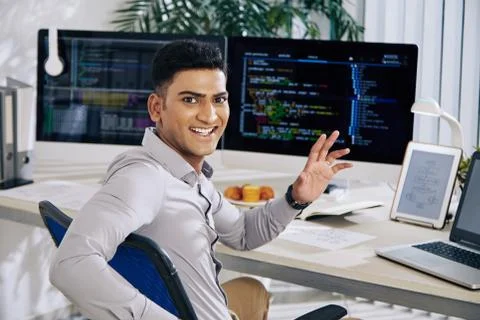 Software developer waving at camera Stock Photos