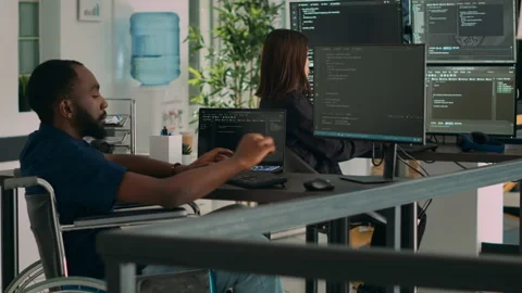 Software developer wheelchair user working on html script code Stock Footage 227613222