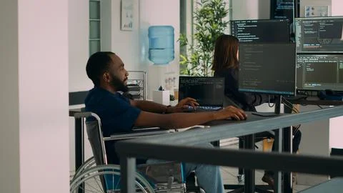 Software developer wheelchair user working on html script code 스톡 사진