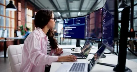 Software Developer Woman Codes Securely On Laptop Using Cloud-based IDE. Stock Photos
