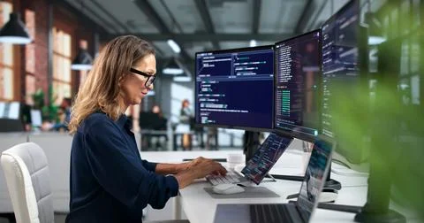 Software Developer Woman Coding Secure Programs On Laptop In Modern Workspace Stock Photos