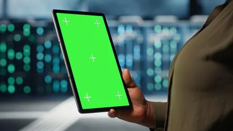 Software developer at work using green screen tablet in data center Foto stock