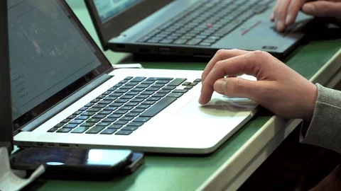 Software developer working behind laptop Stock Footage 74870761