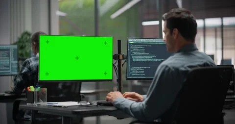 Software Developer Working on Computer with Green Screen Stock Footage 321011873