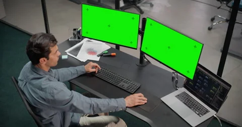Software Developer Working on Computer with Green Screen Stock Footage 321012467
