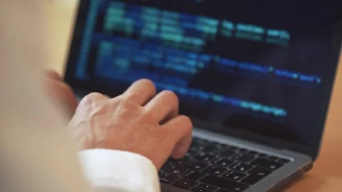 Software developer is working on creating software, typing program code on a Stock Footage 243640019