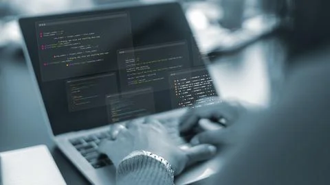 Software developer working on laptop with code overlay.Programmer hands typ.. Foto stock