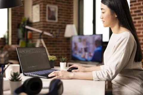 Software developer working on laptop from cozy home Stock Photos