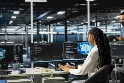 Software developer working in server farm Stock Photos