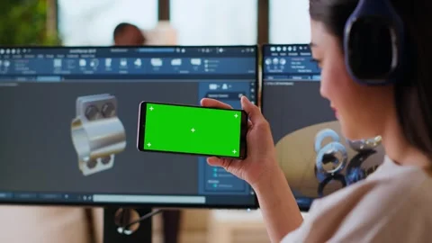 Software developer works in a modern office with green screen and dual monitors Stock Footage 319711125
