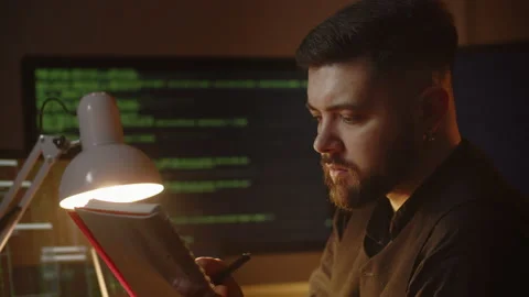 The software developer writes notes in his notebook. Close-up of a male Stock Footage 236773418