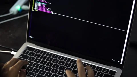 Software Developer Writing Code on Laptop in Modern Workspace Stockbeeldmateriaal 340450267