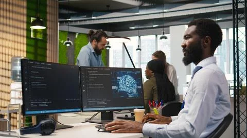 Software developer writing code on PC, developing deep learning APIs Stock Photos
