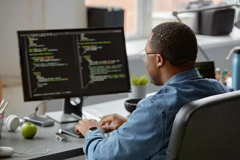 Software Developer Writing Script on Computer Screen Foto stock