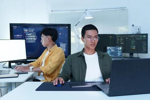 Software Developers Coding with AI Technology in Modern Office Stock Photos