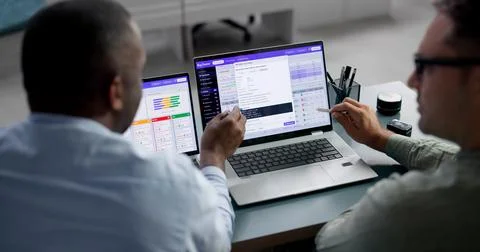 Software Developers Collaborate On Bug Tracking Using Agile Tools And Sprint  Stock Photos