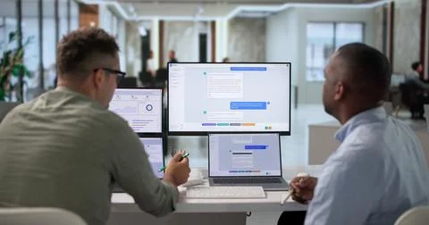 Software Developers Collaborate On Chatbot Design While Coding Advanced Featu Stock Photos