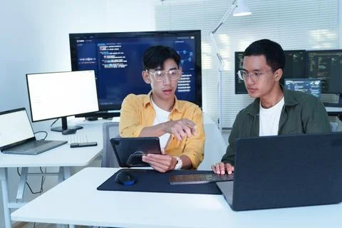 Software Developers Collaborating on AI Technology in Modern Office Stock Photos