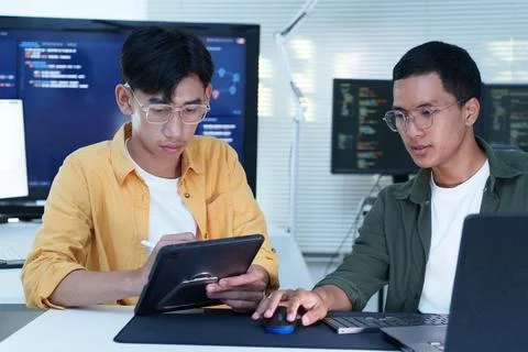 Software Developers Collaborating on Code in Modern Technology Office Stock Photos