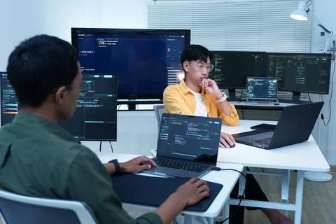 Software Developers Collaborating on Code in a Technology Office Stock Photos